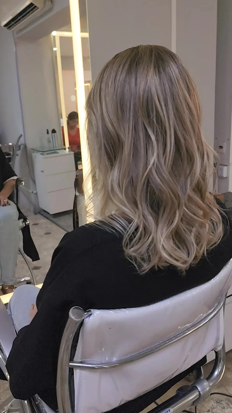Cabelo loiro de comprimento médio com ondas, visto de costas